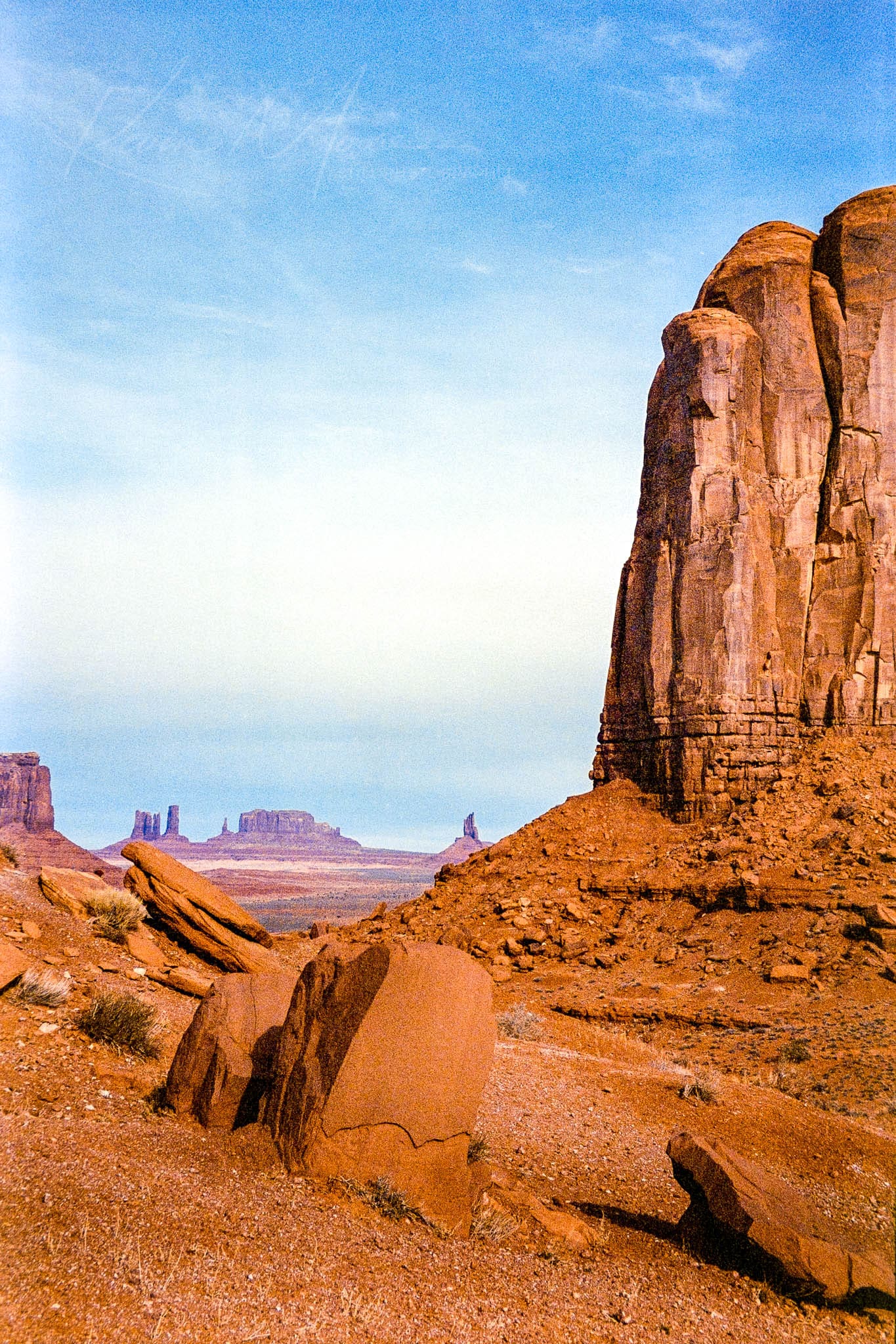 Stunning desert landscape with towering red rock formations under a vibrant blue sky.