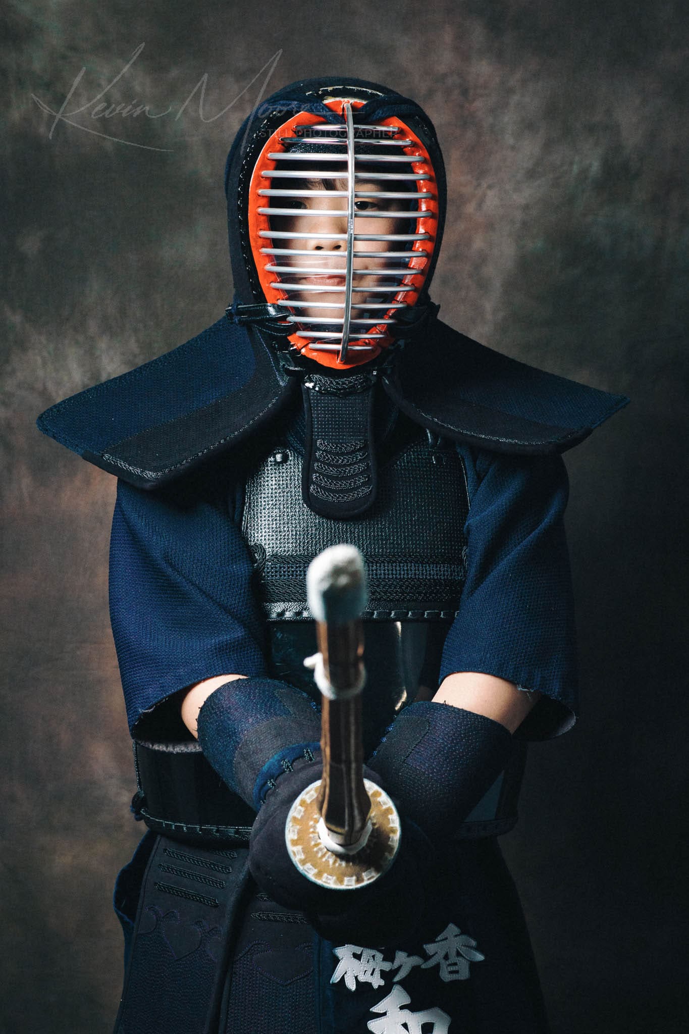 Kendo practitioner in traditional gear with bamboo sword, ready for combat.
