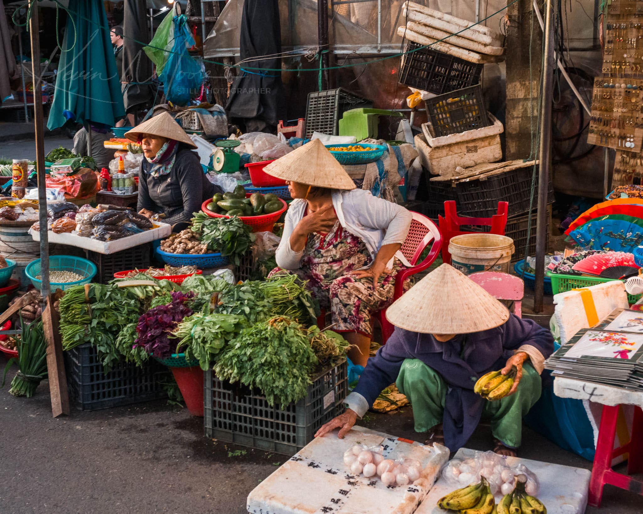 Bustling Vietnam street market with vendors selling fresh produce and local goods.