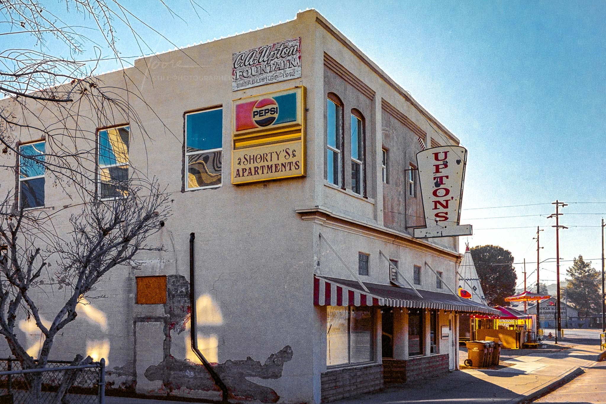Vintage corner building with Jones signage on a peaceful Globe Arizona street.