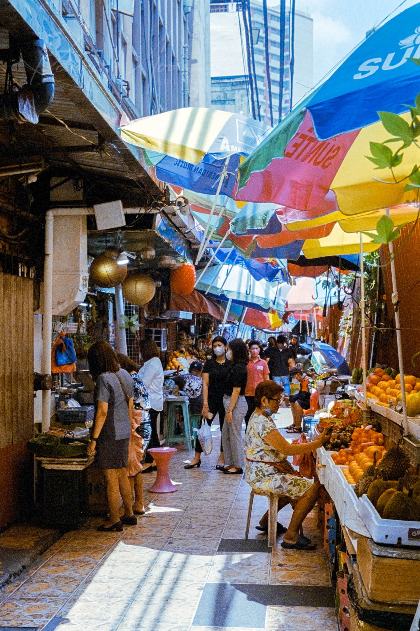 Bustling urban street market brimming with colorful stalls, local goods, and community interactions.