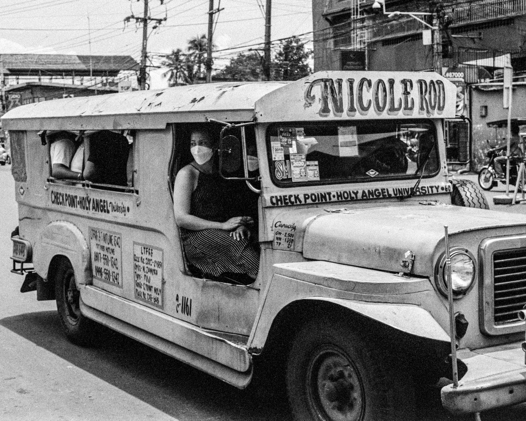 Filipino Jeepney Driver on City Street Promoting Health Messages