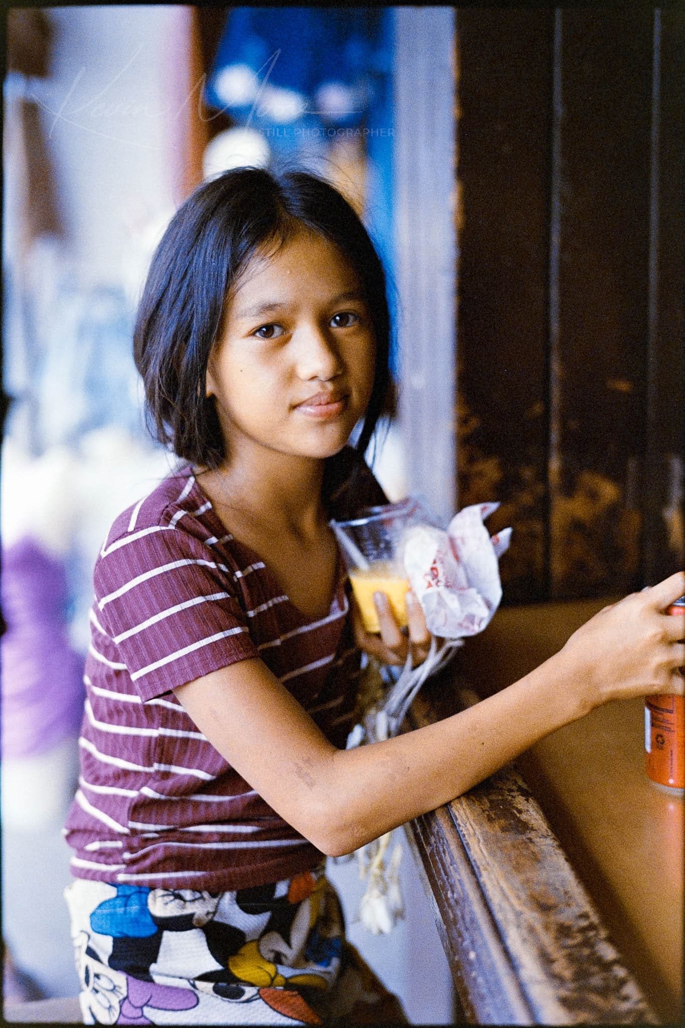 Girl Holding Snack in Bag in Daylit Home Environment