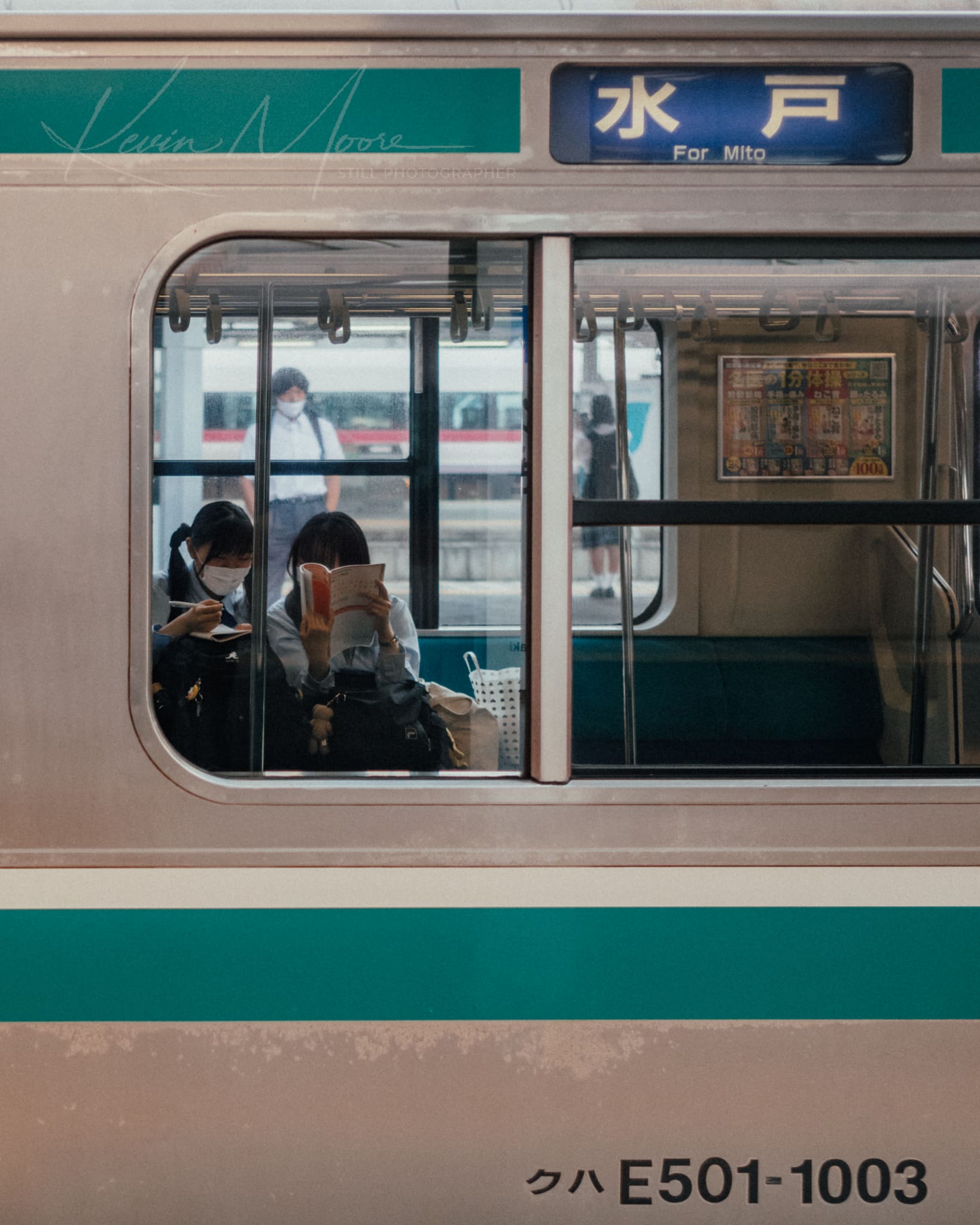 Passengers engrossed in activities inside a Japanese train heading to Mito.
