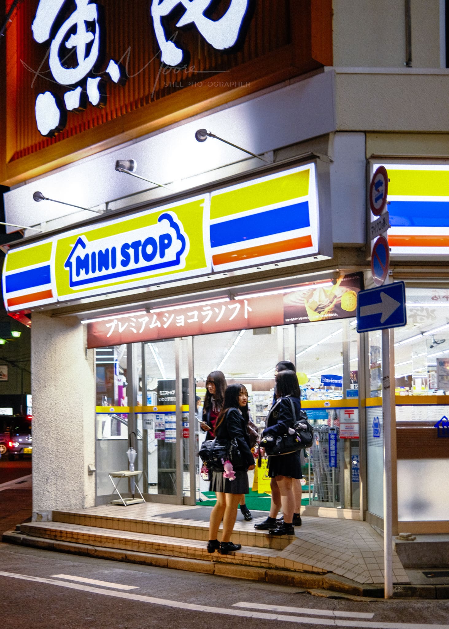 Japanese students at a MINI STOP convenience store during evening.
