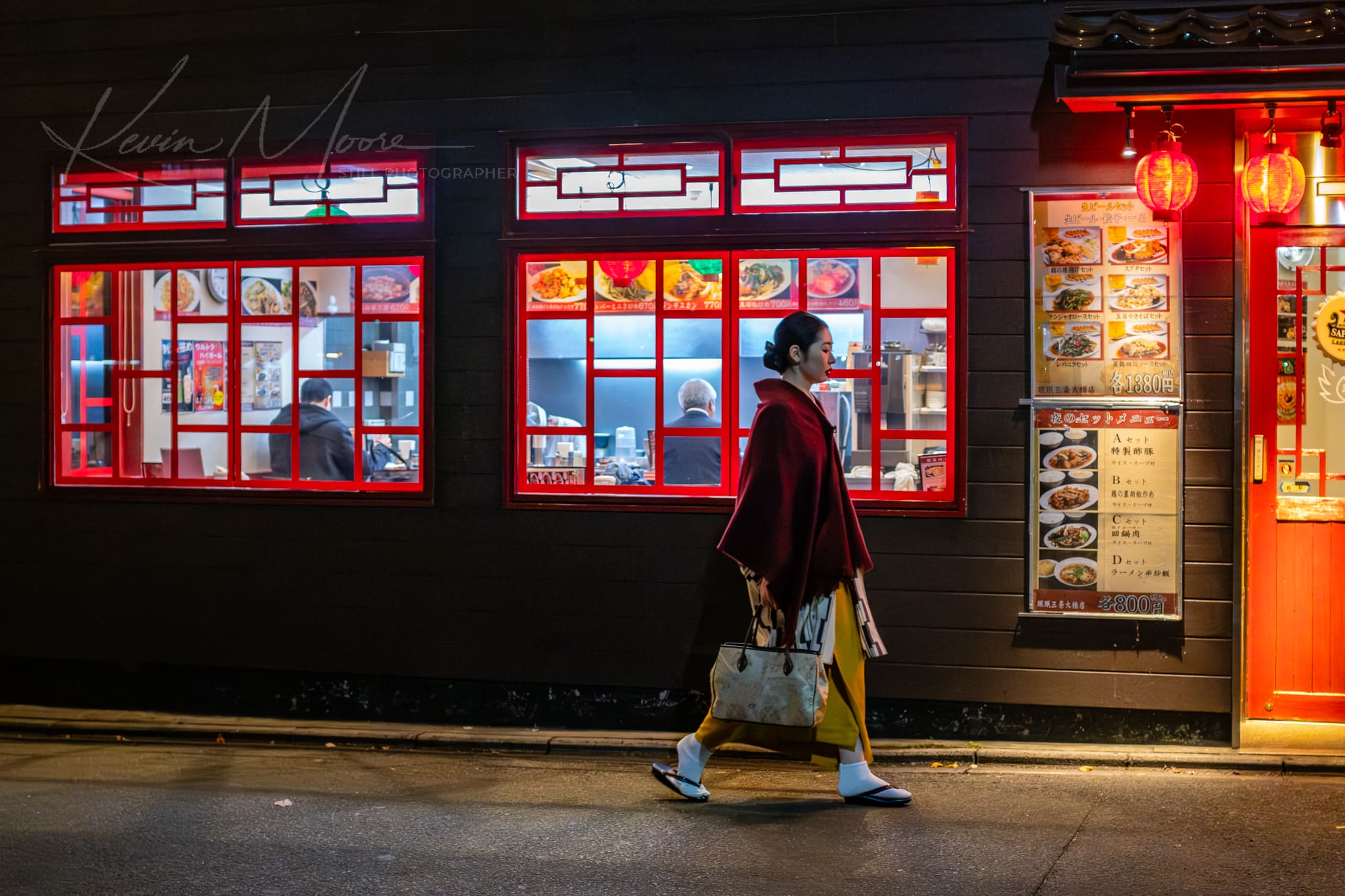 Kyoto woman in kimono passing a vibrant Chinese restaurant on a rainy urban night.