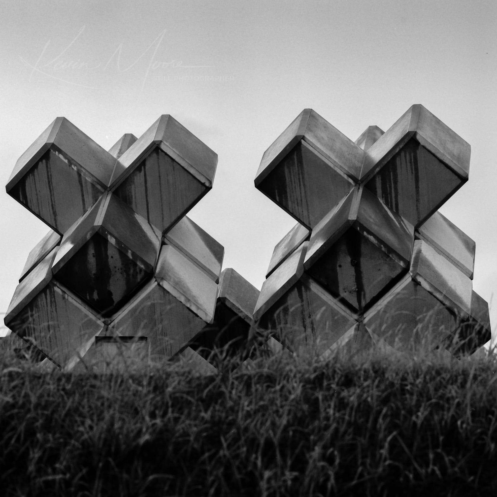 Fine art black and white print of stacked tetrapod forms in rain